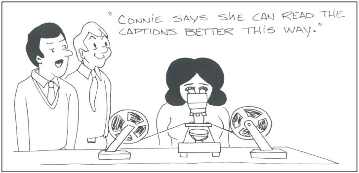 Cartoon drawing of two people looking at a woman who is looking at a roll of movie film through a microscope. One person says, Connie said she can read the captions better this way.