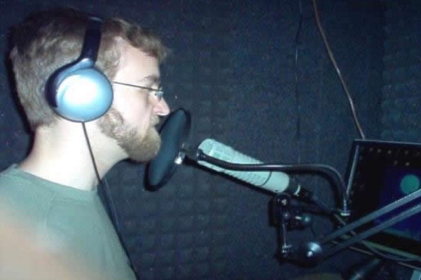 A voicer records description in a modern studio