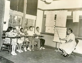 Virginia State School for the Deaf classroom with five black students and a teacher.