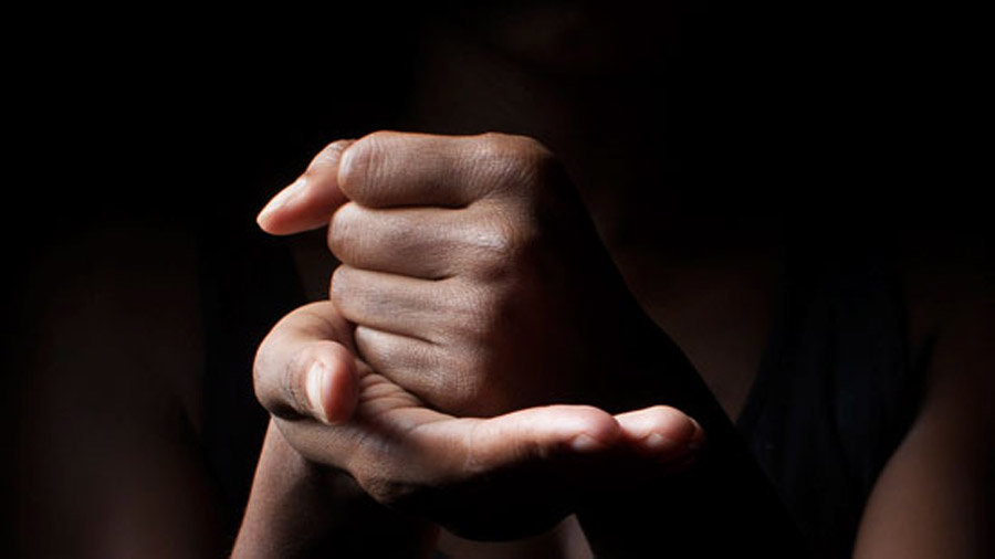 Sign language for help: A fist resting in a palm.
