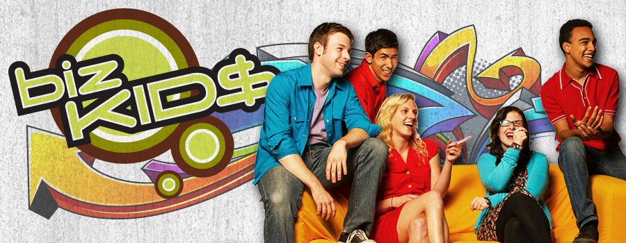 Biz Kids - Five teens cast members sit around an orange sofa, laughing.