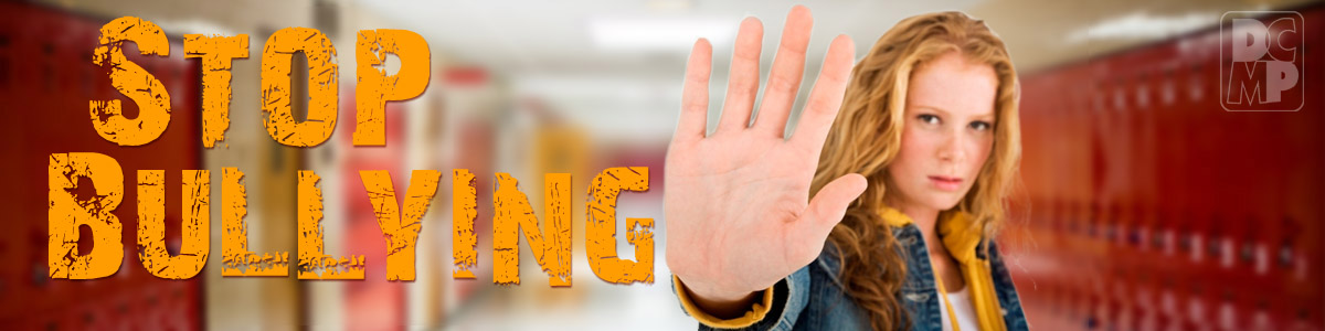 a girl in a school hallway raises her hand to the camera. Text reads Stop Bullying.