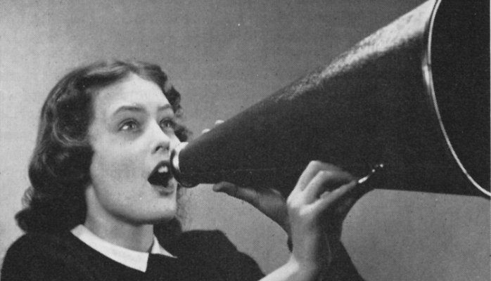 Vintage photo of a young woman yelling into a megaphone