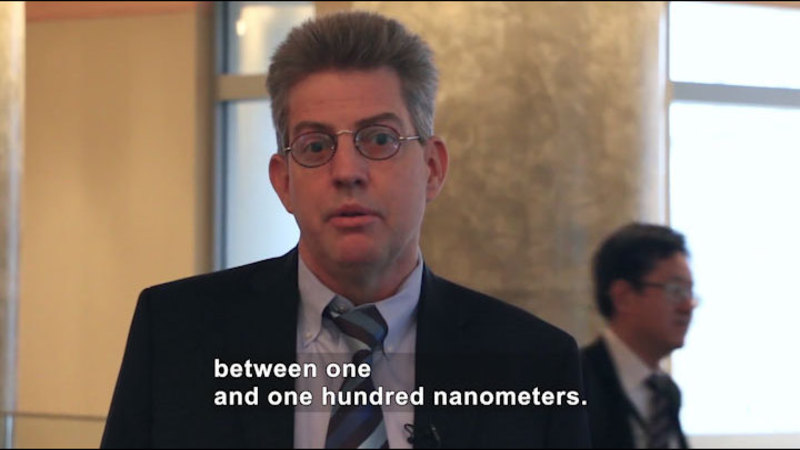 Person speaking. Caption: between one and one hundred nanometers.