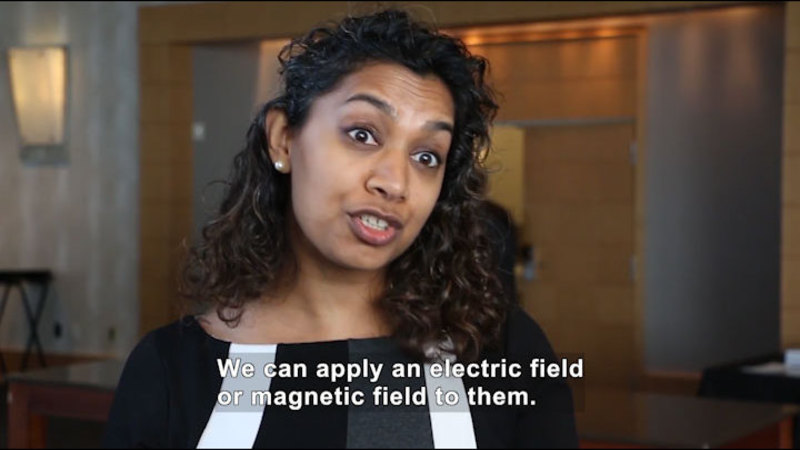 Person speaking. Caption: We can apply an electric field or magnetic fields to them.