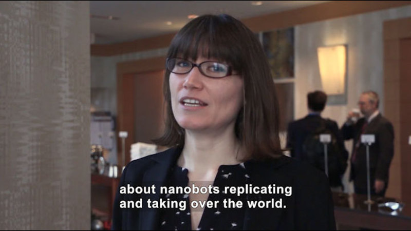 Person speaking. Caption: about nanobots replicating and taking over the world.