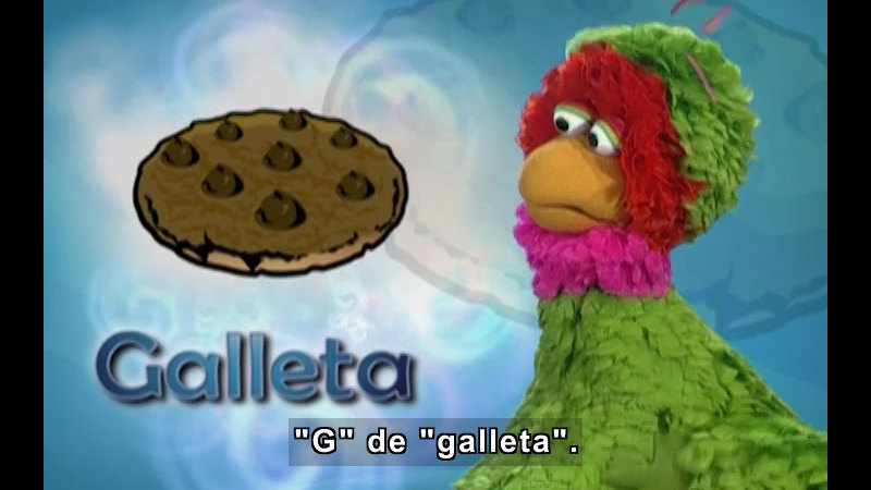 Character looking at an illustration of a cookie. Spanish captions.