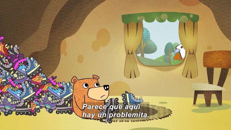 Cartoon of a bear wearing roller-skates sitting on the floor of a house with a giant pile of roller-skates behind him. Spanish captions.