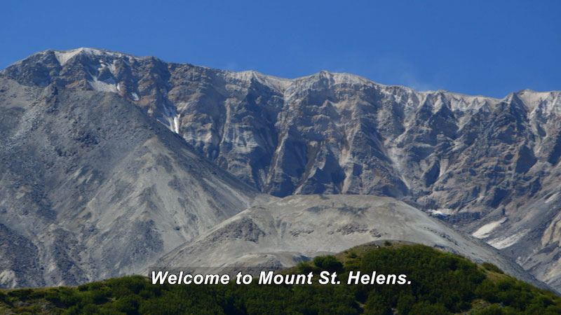 Rocky mountain covered in ash and rocks. Caption: welcome to Mount St. Helens.
