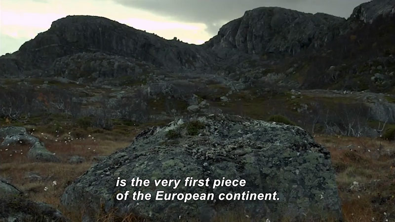Sparse vegetation on a rocky hillside. Caption: is the very first piece of the European continent.