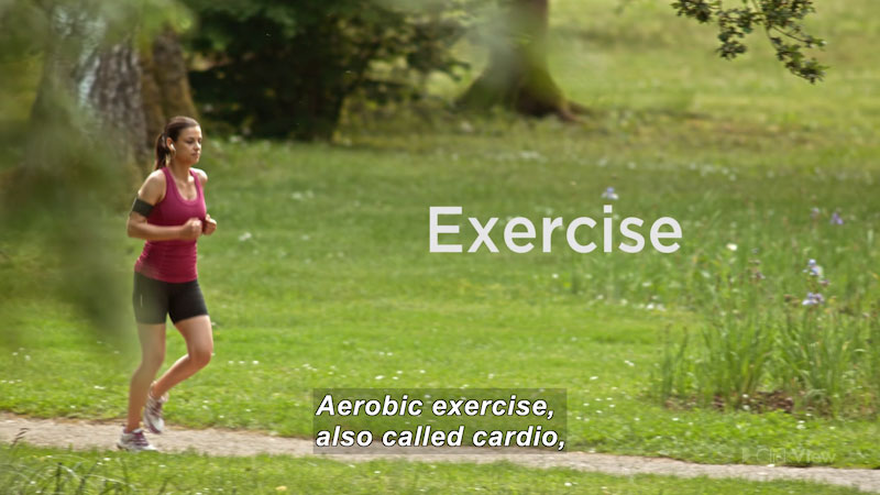 A person jogging on a path. Exercise. Caption: Aerobic exercise, also called cardio,