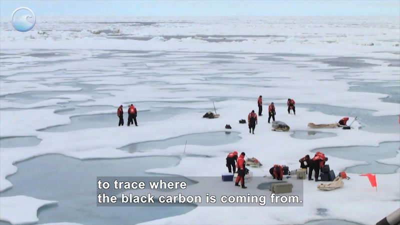 People in full-body orange and black clothing with gear standing on ice in pockets of water. Caption: to trace where the black carbon is coming from.