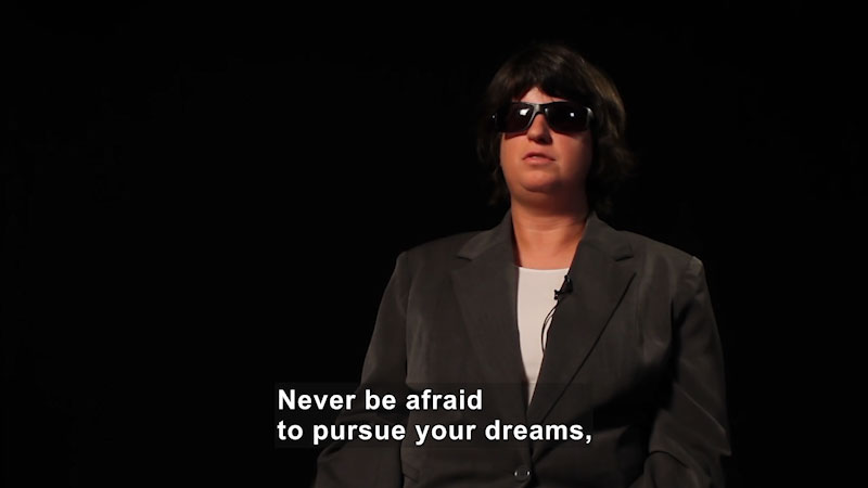 Woman wearing dark sunglasses. Caption: Never be afraid to pursue your dreams,