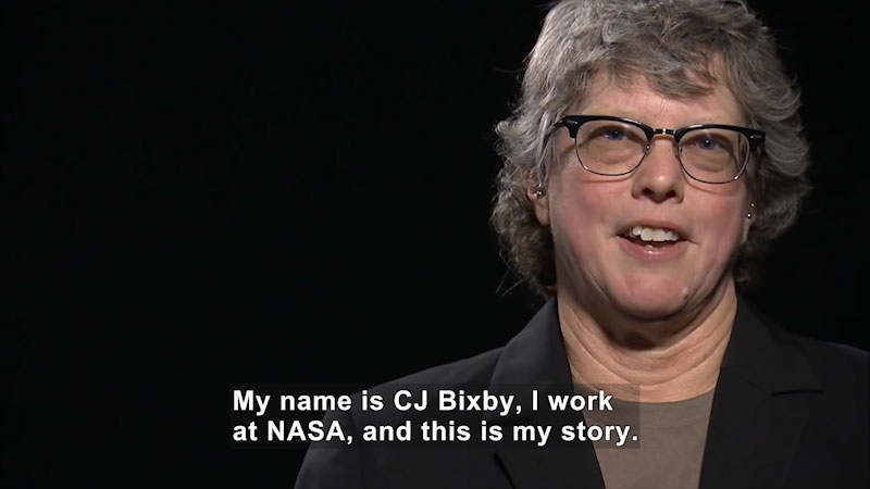 Woman speaking. Caption: My name is CJ Bixby, I work at NASA, and this is my story.