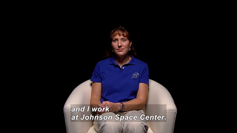 Woman sitting in a chair. Caption: and I work at Johnson Space Center.