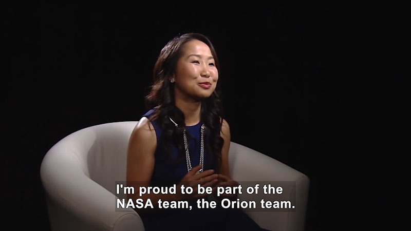 Woman speaking. Caption: I'm proud to be part of the NASA team, the Orion team.