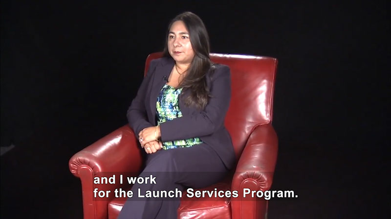 Woman speaking. Caption: and I work for the Launch Services Program.