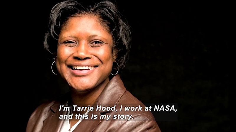 Woman speaking. Caption: I'm Tarrie Hood, I work at NASA, and this is my story.