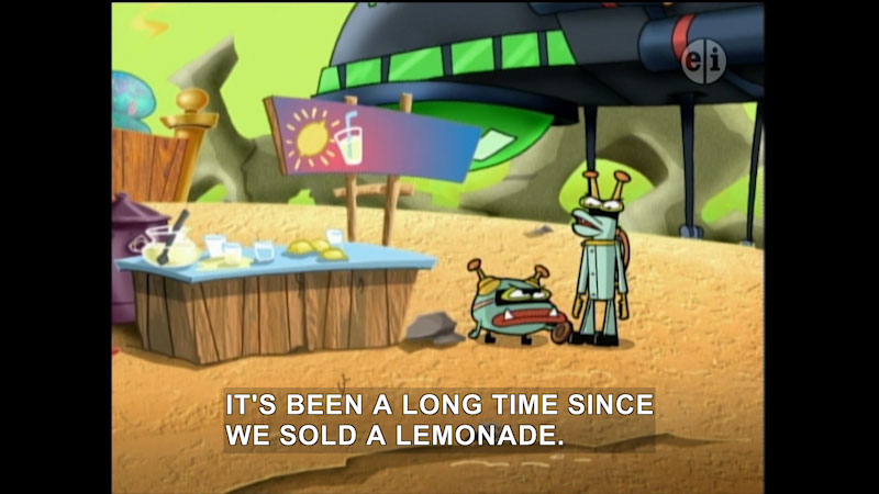 Cartoon of two characters standing next to a table with the makings of lemonade on it. Caption: It's been a long time since we sold a lemonade.