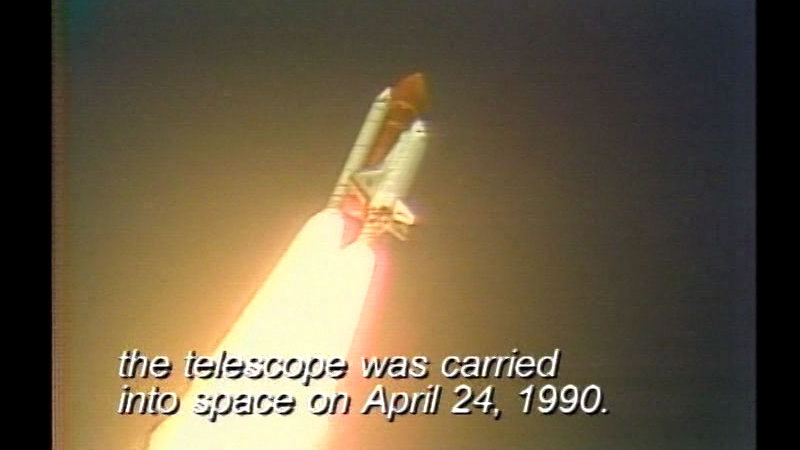 Rocket with multiple engines. Caption: the telescope was carried into space on April 24, 1990.