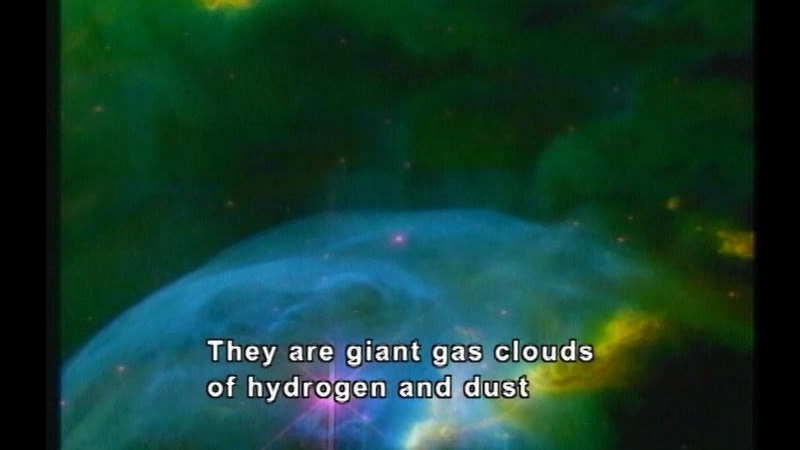 Nebulous clouds of brightly colored gas with points of light visible through the gas. Caption: They are giant gas clouds of hydrogen and dust