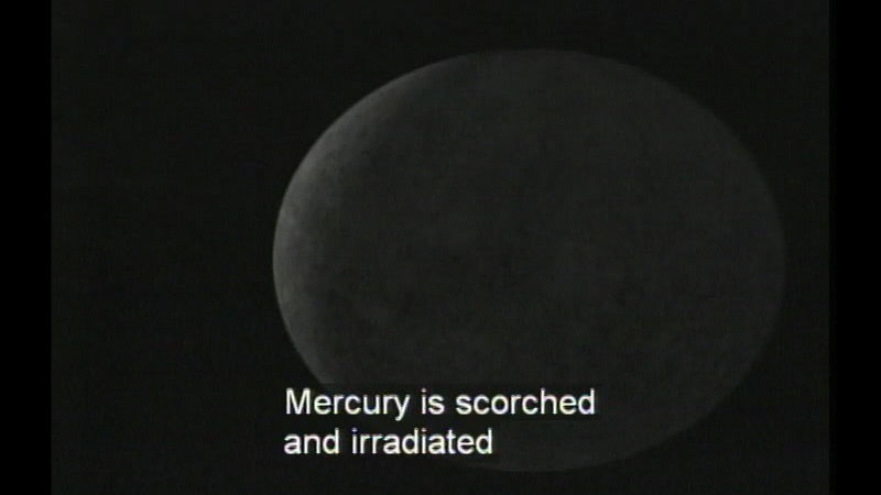 Black and white photograph of a spherical object against a black sky. Caption: Mercury is scorched and irradiated