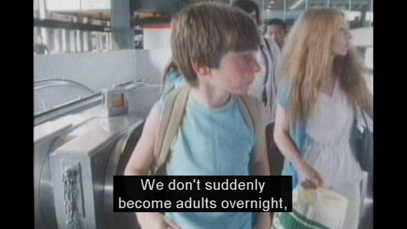 Child at the top of an escalator. Caption: We don't suddenly become adults overnight,