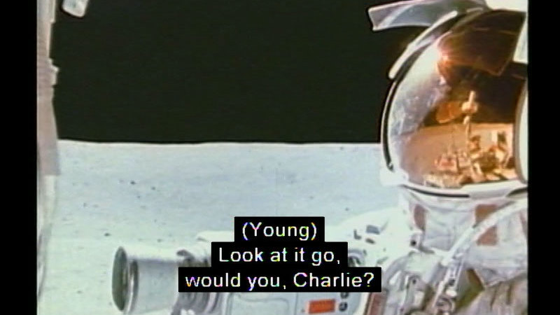 Astronaut in a space suit on the surface of the moon. Caption: (Young) Look at it go, would you, Charlie?