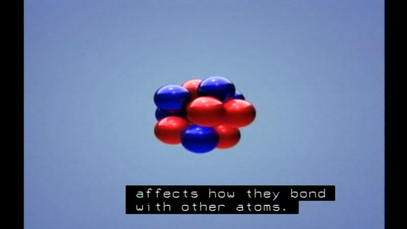 Blue and red spheres form a larger spherical shape. Caption: affects how they bond with other atoms.