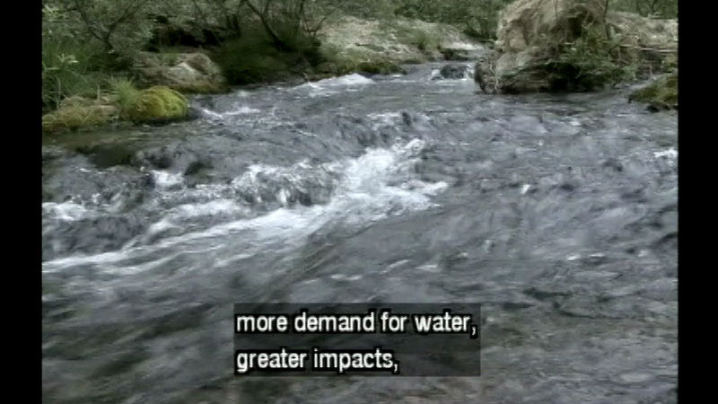 A swiftly moving river. Caption: more demand for water, greater impacts,