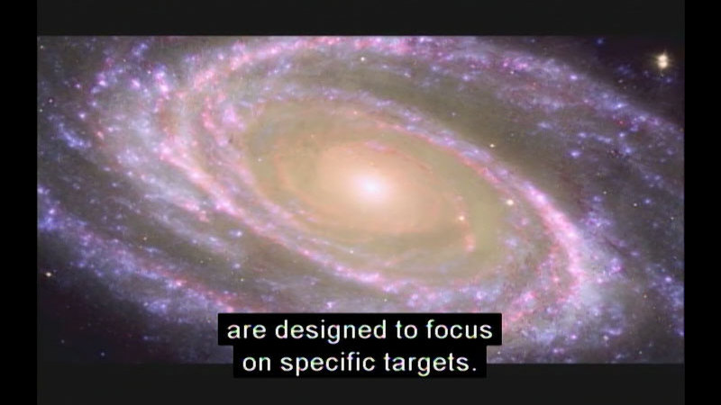 A spiral galaxy with glowing lights throughout the arms of the spiral and a bright glowing light at the center. Caption: are designed to focus on specific targets.