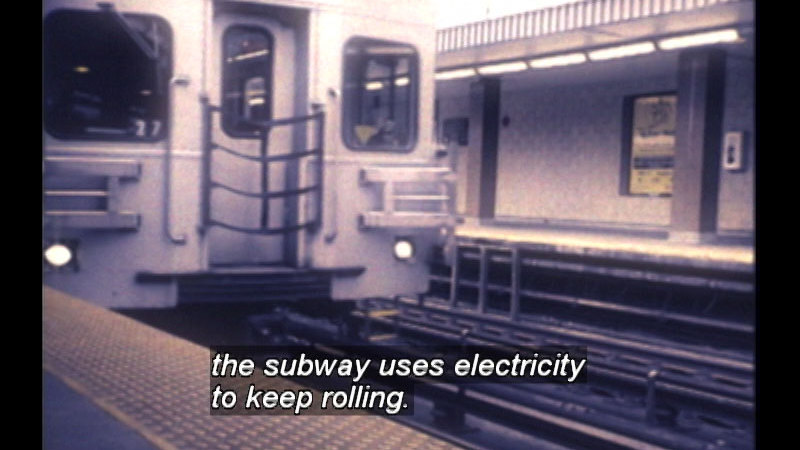 A train in a subway station. Caption: the subway uses electricity to keep rolling. 