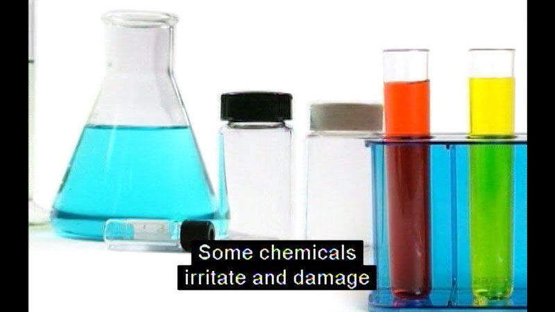 Beakers and test tubes with colored liquid. Caption: Some chemicals irritate and damage