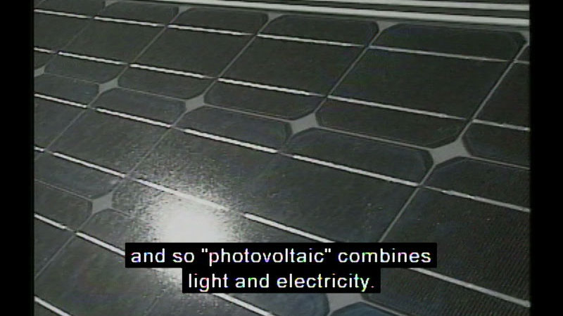 Closeup of a solar panel. Caption: and so "photovoltaic" combines light and electricity.