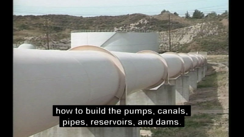 Giant industrial pipe running across the landscape with an industrial storage tank in the background. Caption: how to build the pumps, canals, pipes, reservoirs, and dams.