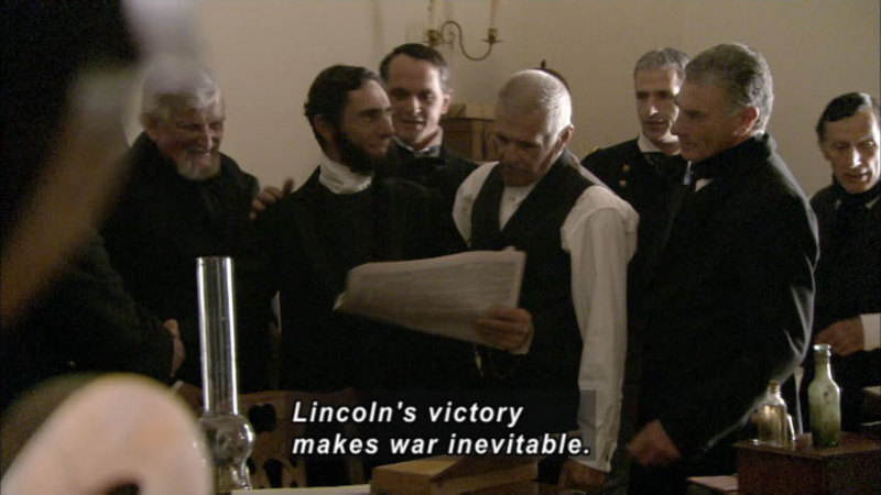 Men in waistcoats stand clustered together, looking at papers being held by one of them. Caption: Lincoln's victory makes war inevitable.