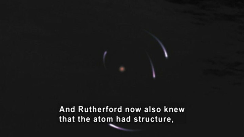 Dark background with a small central ball of light surrounded by four irregularly placed orbiting streaks of light. Caption: And Rutherford now also knew that the atom had structure,