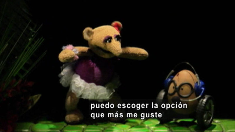 Two puppets facing each other.  Spanish captions.