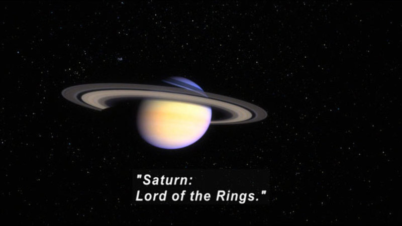 View of Saturn in space. Caption: "Saturn: Lord of the Rings."