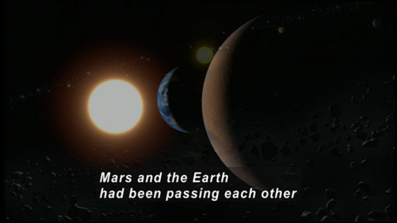 Earth and Mars passing each other in space. Caption: Mars and the Earth had been passing each other