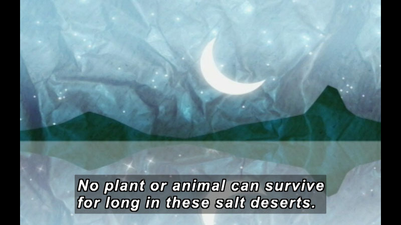 Illustration of mountains and the night sky with a crescent moon reflected on water. Caption: No plant or animal can survive for long in these salt deserts.