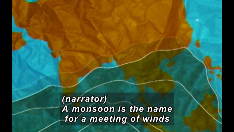 Map of the Eurasian continent and pacific islands, as well as the Indian and Pacific oceans. Caption: (narrator) A monsoon is the name for a meeting of winds