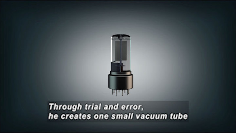 A clear glass tube with a flat object inside. On the bottom it is encased in metal with prongs so that it can plug into something. Caption: Through trial and error, he creates one small vacuum tube