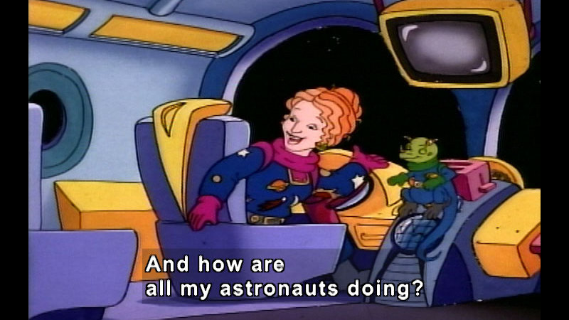 Ms. Frizzle and Liz at the controls of a spaceship. Caption: And how are all my astronauts doing?