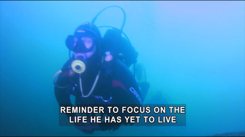 Person in scuba gear underwater. Caption: reminder to focus on the life he has yet to live