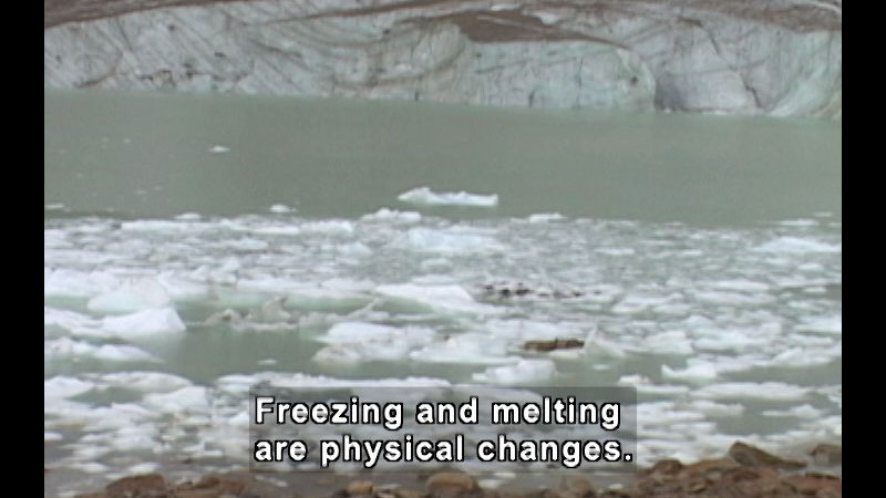 Water with chunks of ice floating in it. Caption: Freezing and melting are physical changes.
