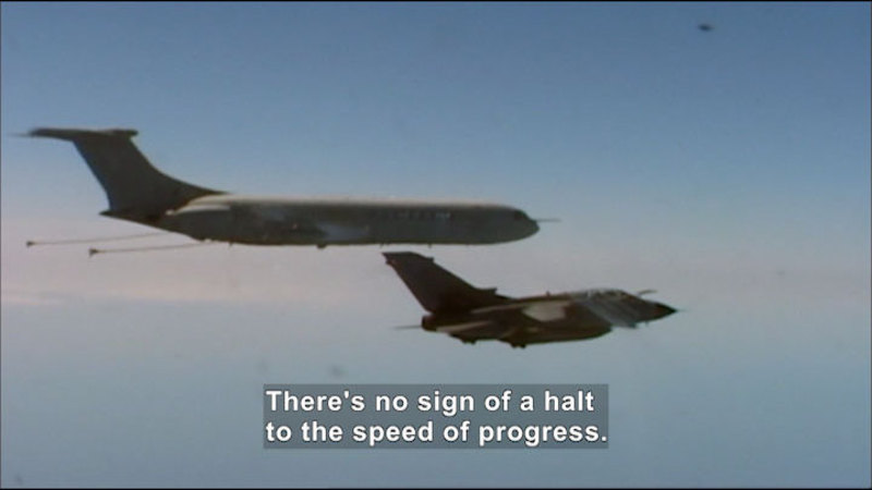 A large jetliner flies above and very close to a smaller, angular space craft. Caption: There's no sign of a halt to the speed of progress.