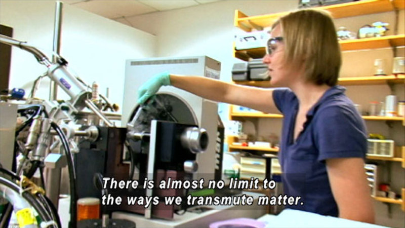 Person in a science lab working with complex machinery. Caption: There is almost no limit to the ways we transmute matter.