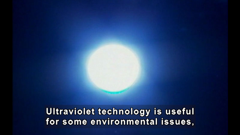 Bright glowing sphere against a blue sky. Caption: Ultraviolet technology is useful for some environmental issues,