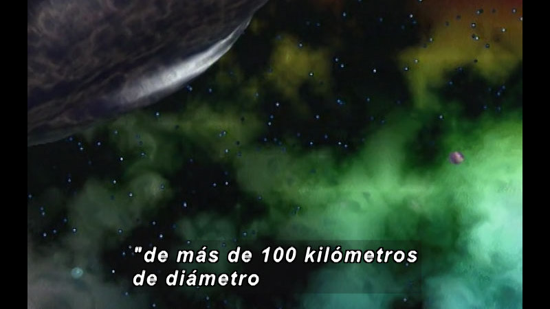 Illustration of a small spherical object in greenish gas clouds near the surface of a larger object. Spanish captions.